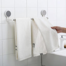 Towel rack bar installed on bathroom wall using adhesive mount