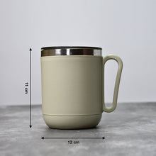 An Indian man enjoying a hot beverage from the Ganesh stainless steel coffee mug.