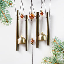 Lord Ganesh Wind Chimes displayed in garden setting creating peaceful ambiance