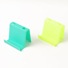 Top view of multifunctional mobile phone stand and pen holder in assorted colors