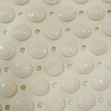 Flexible anti-slip bath mat folded to show versatility and easy storage