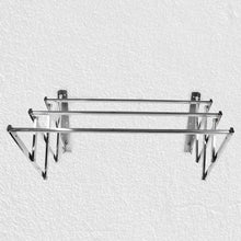 Close-up of wall-mounted stainless steel folding drying rack fully extended