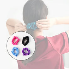 Four soft elastic hair scrunchies displayed together, showcasing the gentle fabric and robust elastic.