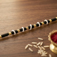 Handcrafted black and white beaded thread rakhi
