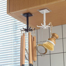 A hand demonstrating the 360-degree rotation of the self-adhesive wall hook.