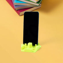 Hexagonal plastic mobile phone stand holding smartphone securely