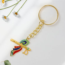 Back view of metal Krishna flute keychain highlighting craftsmanship
