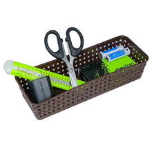 A brown rectangular plastic basket filled with scissors, a cutter, and batteries on a white background.