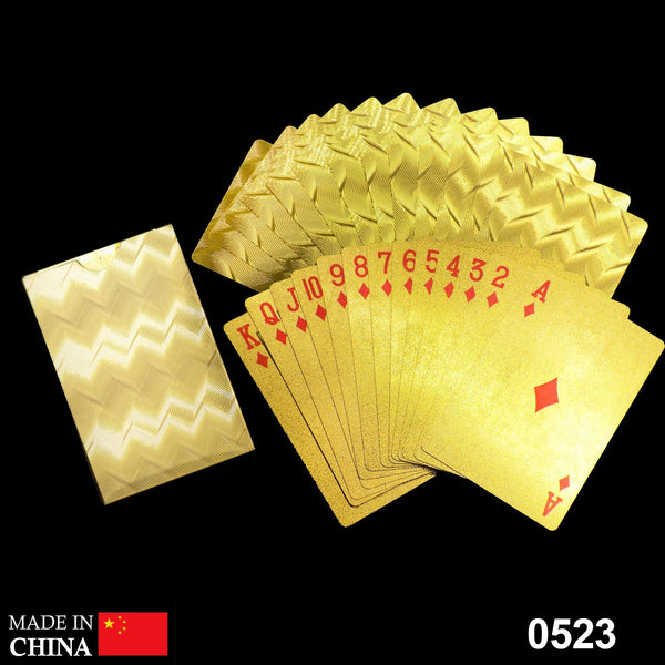 Gold plated playing cards shimmering on a table, ready for a game.