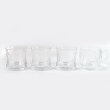 Stackable glass tumblers and mugs, part of a durable and practical drinkware collection.