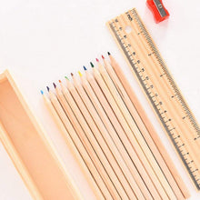 The wooden ruler and the colorful pencil box, essential accessories from the art kit.