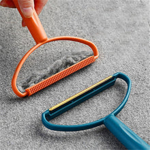 Portable lint remover with long handle, demonstrating its dual fabric brush and copper blade.