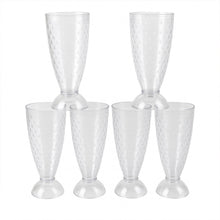 Transparent plastic milkshake glasses neatly arranged on a dining table