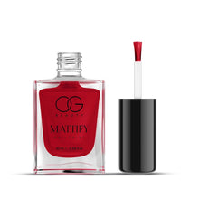 Woman applying quick-dry red matte nail polish for an elegant and stylish look.