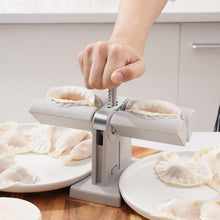 Double head dumpling maker mold in use, creating two perfectly shaped dumplings.