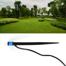 A black and blue water dripper with a thin black hose, with an upper image of a lush green park with trees and manicured