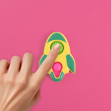 Child's hands playing with the rocket-shaped fidget keychain toy