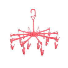 Close-up of the clothes clips hanger securely holding baby clothes for quick drying.