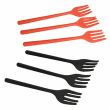 Multiple colorful silicone flexible forks stacked together, showcasing their soft texture.