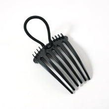 Hair styling comb clip securing hair in a voluminous bun style