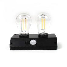 Two bright LED bulbs of the Indo Glow solar lamp clearly visible.