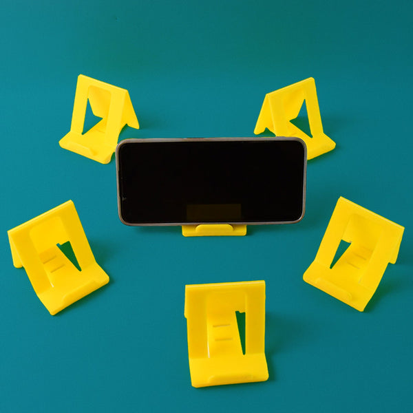 Foldable plastic mobile phone stand supporting a smartphone at an angle