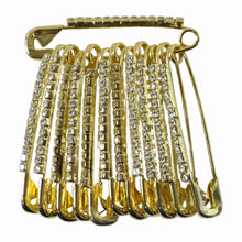 Golden safety pin brooch clips viewed from top showcasing smooth edges