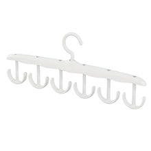Side view of the space-saving tank top hanger with garments, showcasing its slim profile.