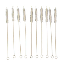 Nylon bristles cleaning a reusable metal straw with the brush from the set
