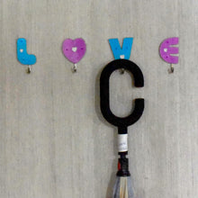 Decorative love shape self adhesive hooks enhancing room aesthetics.