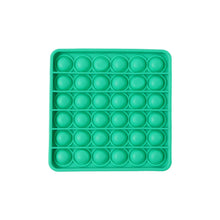 A standalone image of a square green silicone pop-it fidget toy on a white background.