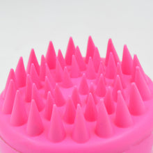 Scalp cleansing brush with ergonomic handle for deep hair wash.