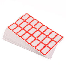 A stack of white labels with red borders, fanned out slightly, on a white background.