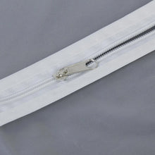 Closeup of full-length zipper on suit cover with breathable fabric.