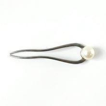 Close-up of pearl hair pin detail