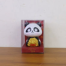 Multiple solar panda figurines in various poses, emphasizing their charm as car interior accessories.