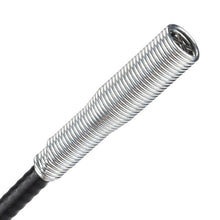 Close-up of the silver coiled spring section of the drain cleaner, extending from the black flexible shaft.