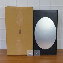 Stylish black wall-mounted storage box with front oval mirror for grooming essentials storage cabinet