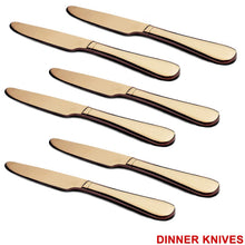 Top-down view of a single gold dinner knife and spoon.