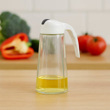 Glass oil bottle dispenser showing measuring marks and leak-proof spout