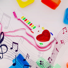 The battery-operated mini guitar toy with a focus on its light-up elements.