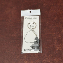 Display of durable metal Shivling keychain with snake design