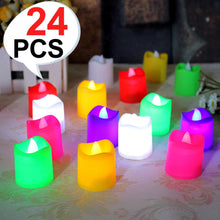 Sixteen glowing multicolor LED tealight candles arranged on a patterned surface with a