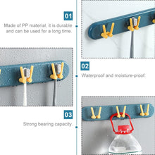 Modern wall-mounted bathroom shelf with hooks, perfect for hygienic toothbrush storage.
