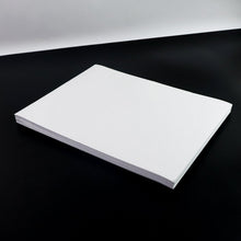 White A4 self-adhesive label sheets stacked neatly for printing