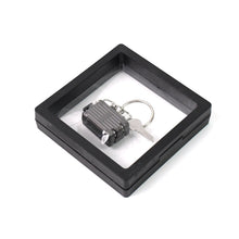Nail clipper keychain attached to travel essentials with suitcase shape