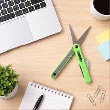 Close-up view of the sharp blades on the portable pen-style scissors. pen scissors