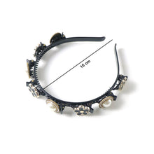 Close-up of elegant pearl & floral hairband showing detailed design