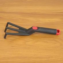 Garden maintenance with plastic hand garden cultivator