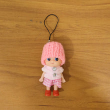 Vibrant outfit of mini doll keychain in colorful setting